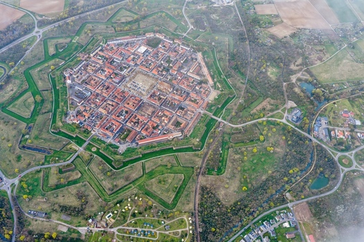 Aerial view of the star shaped fortress city its red tiled roofs contrasting with the green moats and surrounding forests Neuf Brisach Grand Est France.