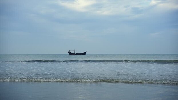 View of a traditional fishing boat on the calm sea Bangladesh.