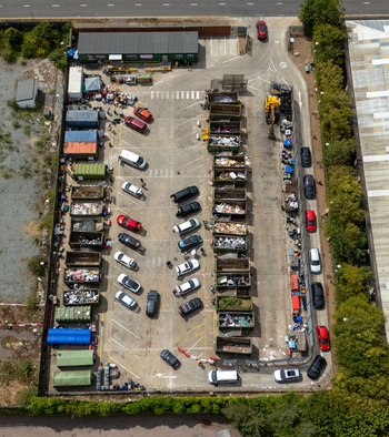 Aerial view of Stevenage Recycling Centre with rows of waste containers parked vehicles and industrial facility infrastructure Stevenage England United Kingdom.