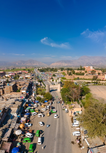 Aerial view of the historic Khyber Pass with bustling traffic surrounding buildings and rugged mountains in the background in Khyber District Khyber Pakhtunkhwa Pakistan. Aerial view of the historic Khyber Pass with bustling traffic surrounding buildings and rugged mountains in the background in Khyber District Khyber Pakhtunkhwa Pakistan.