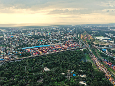 Aerial view of Chattogram Port with its container terminal surrounding urban landscape lush green areas and industrial infrastructure in Chittagong Chittagong Division Bangladesh.