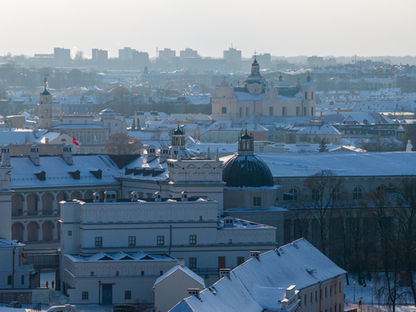 Aerial view of the snow covered historic rooftops and church domes of the old town under a clear winter sky Vilnius County Lithuania.