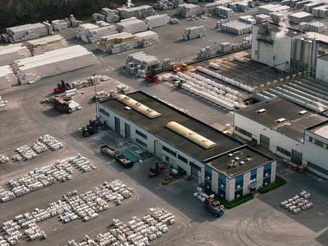Aerial view of an industrial facility with warehouses storage yards filled with palletized goods and forklifts operating in the yard in Dulmen North Rhine Westphalia Germany. Aerial view of an industrial facility with warehouses storage yards filled with palletized goods and forklifts operating in the yard in Dulmen North Rhine Westphalia Germany.