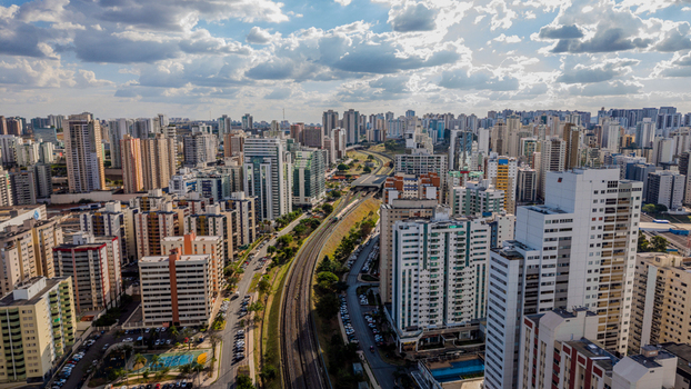 Brasilia Brazil 12 September 2026 Aerial view of the modern urban skyline and railway tracks cutting through the city with high rise buildings under a cloudy sky.