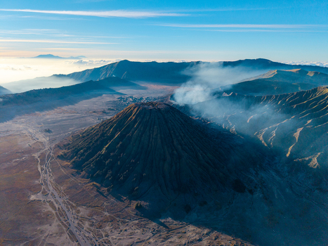 Aerial view of Gunung Batok with its ridged slopes and volcanic crater set within the vast Tengger Caldera landscape in Kecamatan Tosari Jawa Timur Indonesia. Aerial view of Gunung Batok with its ridged slopes and volcanic crater set within the vast Tengger Caldera landscape in Kecamatan Tosari Jawa Timur Indonesia.