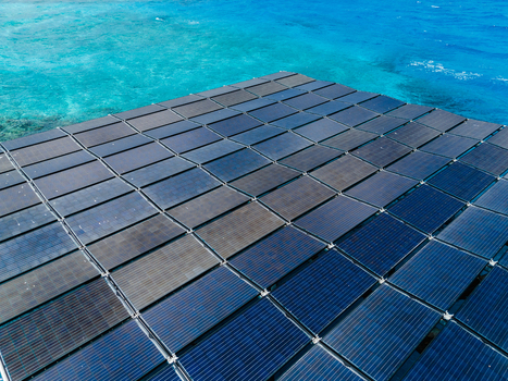 Aerial view of SolarSea floating solar power plant by Swimsol with rows of photovoltaic panels on turquoise ocean water in Dharavandhoo Baa Atoll Maldives. Aerial view of SolarSea floating solar power plant by Swimsol with rows of photovoltaic panels on turquoise ocean water in Dharavandhoo Baa Atoll Maldives.