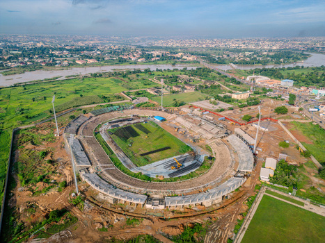 Aerial view of Ahmadu Bello Stadium surrounded by green fields and urban landscape near the river in Kaduna Kaduna Nigeria. Aerial view of Ahmadu Bello Stadium surrounded by green fields and urban landscape near the river in Kaduna Kaduna Nigeria.