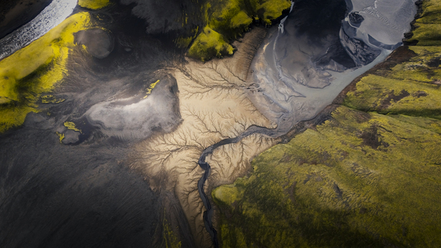 Aerial view of the Langisjor area featuring intricate braided river channels cutting through black volcanic sand and vibrant green mossy terrain in Vik Skaftarhreppur Iceland. Aerial view of the Langisjor area featuring intricate braided river channels cutting through black volcanic sand and vibrant green mossy terrain in Vik Skaftarhreppur Iceland.