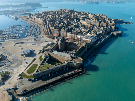 Aerial view of the walled city against the turquoise sea a fortress with ramparts and a harbor filled with boats Saint Malo Brittany France. Aerial view of the walled city against the turquoise sea a fortress with ramparts and a harbor filled with boats Saint Malo Brittany France.