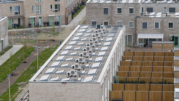 Aerial view of modern residential buildings with solar panels and air conditioning units on flat roofs in Almere Flevoland Netherlands. Aerial view of modern residential buildings with solar panels and air conditioning units on flat roofs in Almere Flevoland Netherlands.