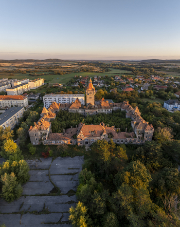 Aerial view of the historic Hajmasker Barracks with its overgrown central courtyard and red tiled roofs set within the village of Hajmasker Hungary. Aerial view of the historic Hajmasker Barracks with its overgrown central courtyard and red tiled roofs set within the village of Hajmasker Hungary.