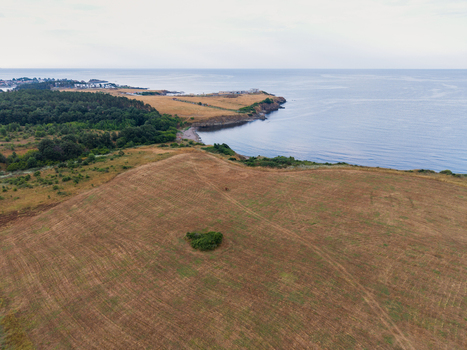 Aerial view of Arapya coastline with dry fields green vegetation and calm sea in Burgas Bulgaria. Aerial view of Arapya coastline with dry fields green vegetation and calm sea in Burgas Bulgaria.