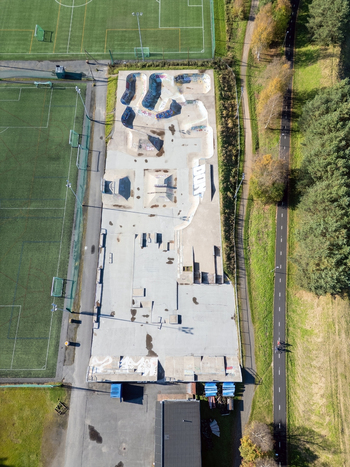 Oulu Finland 25 September 2026 Aerial view of the skate park featuring concrete ramps and bowls situated next to a soccer field and a forest path. Oulu Finland 25 September 2026 Aerial view of the skate park featuring concrete ramps and bowls situated next to a soccer field and a forest path.