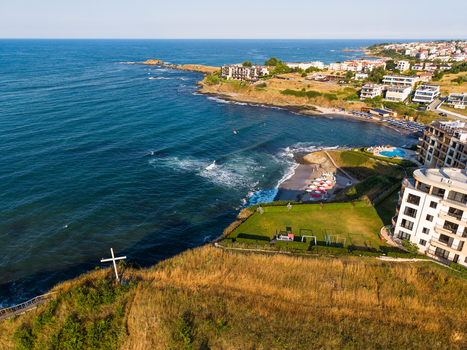 Aerial view of the Lozenets Northern Cross standing on a grassy cliff overlooking the Black Sea with coastal hotels and sandy beaches in Lozenets Burgas Bulgaria. Aerial view of the Lozenets Northern Cross standing on a grassy cliff overlooking the Black Sea with coastal hotels and sandy beaches in Lozenets Burgas Bulgaria.