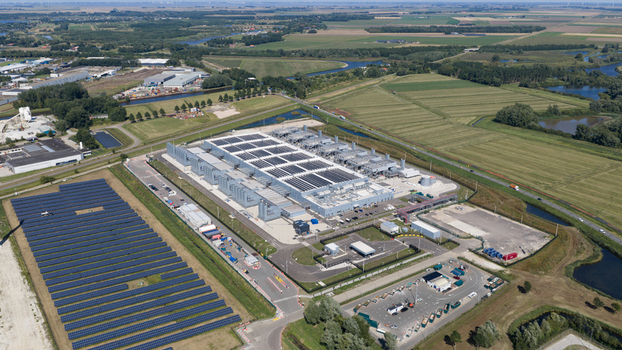 Aerial view of the HGB high voltage substation surrounded by solar panels green fields and waterways in Winschoten Groningen Netherlands.