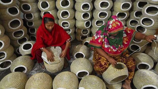 View of women weaving traditional baskets in Bogura Bangladesh. View of women weaving traditional baskets in Bogura Bangladesh.