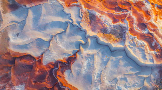 Aerial view of the colorful badlands with intricate geological patterns and cracked earth formations in Hanksville Utah United States.