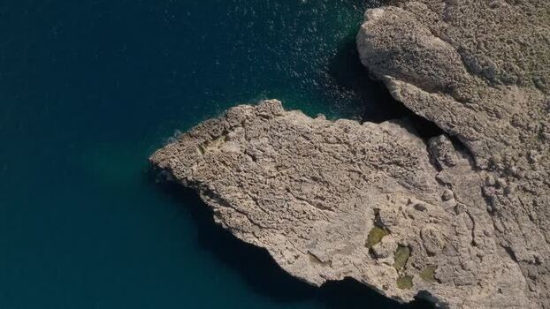 Aerial view of the rugged rocky coastline of Plemmirio Italy.