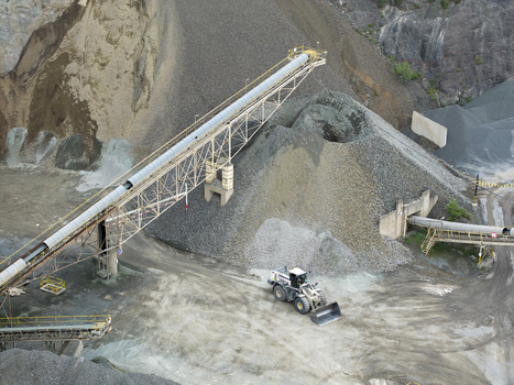 Aerial view of the kopalnia porfiru i diabazu featuring industrial conveyor belts large piles of stone and a front end loader operating in Krakow Lesser Poland Voivode Poland. Aerial view of the kopalnia porfiru i diabazu featuring industrial conveyor belts large piles of stone and a front end loader operating in Krakow Lesser Poland Voivode Poland.