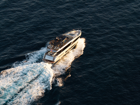 Aerial view of a luxury yacht cruising on the deep blue sea leaving a white wake behind in Antibes Provence Alpes Cote d Azur France. Aerial view of a luxury yacht cruising on the deep blue sea leaving a white wake behind in Antibes Provence Alpes Cote d Azur France.