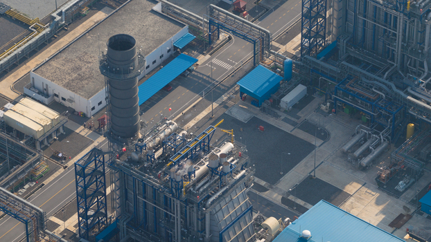 Aerial view of the Gulf PD Power Plant featuring industrial chimneys complex steel structures and blue roofed buildings Map Yang Phon Rayong Thailand. Aerial view of the Gulf PD Power Plant featuring industrial chimneys complex steel structures and blue roofed buildings Map Yang Phon Rayong Thailand.