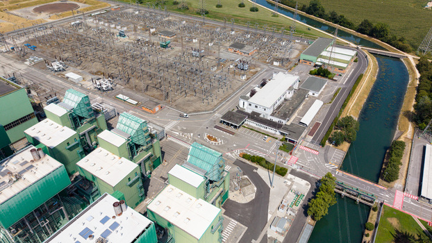 Aerial view of the TTEP Tavazzano thermal power plant and TERNA electrical substation with industrial buildings power lines and a nearby canal in Tavazzano con Villavesco Lombardy Italy.