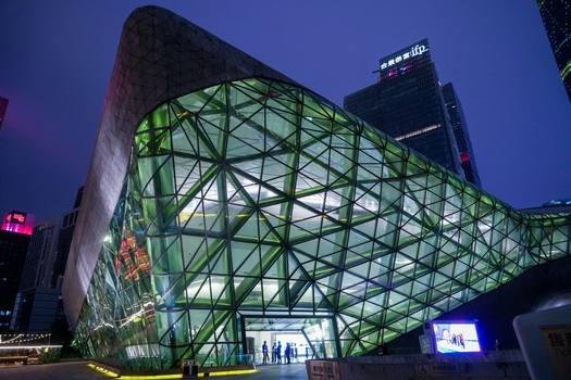 Guangzhou China 24 February 2024 View of the Guangzhou Grand Theatre with its striking glass and steel geometric facade illuminated at night. Guangzhou China 24 February 2024 View of the Guangzhou Grand Theatre with its striking glass and steel geometric facade illuminated at night.