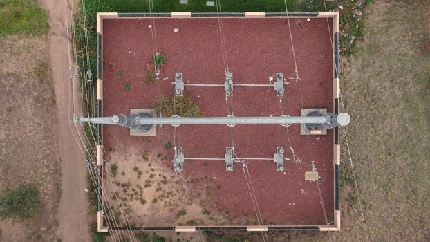 Aerial view of an electrical substation with power lines gravel ground and surrounding vegetation in Denver Colorado United States. Aerial view of an electrical substation with power lines gravel ground and surrounding vegetation in Denver Colorado United States.