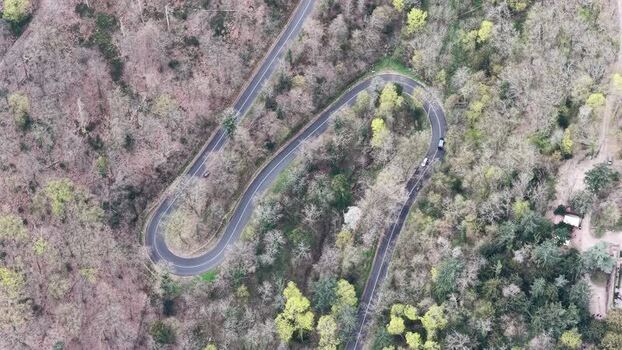 Aerial view of winding road through forest France.