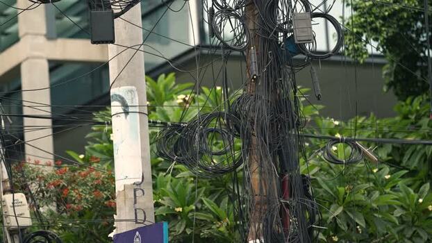 View of tangled electrical wires on a utility pole Bangladesh.