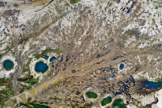 Aerial view of sandy terrain with intricate tire tracks and small blue and green water filled pits in Panchagarh Rangpur Division Bangladesh. Aerial view of sandy terrain with intricate tire tracks and small blue and green water filled pits in Panchagarh Rangpur Division Bangladesh.