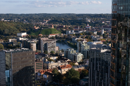Aerial view of Gediminas Tower and the historic old town skyline with the Neris River flowing through modern and traditional architecture in Vilnius Vilnius County Lithuania.