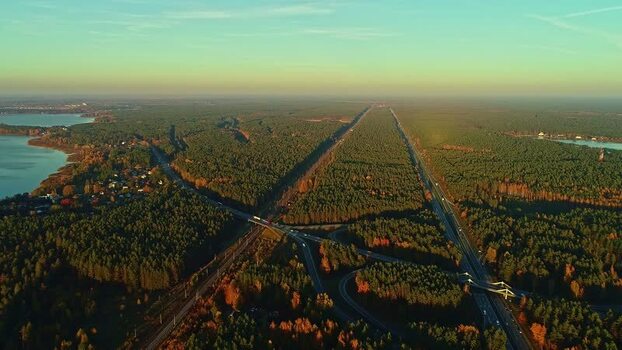 Aerial view of highway through forest in Latvia.