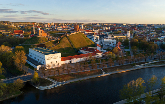 Aerial view of Gediminas Tower and the Palace of the Grand Dukes of Lithuania by the river under golden hour light Vilnius County Lithuania. Aerial view of Gediminas Tower and the Palace of the Grand Dukes of Lithuania by the river under golden hour light Vilnius County Lithuania.