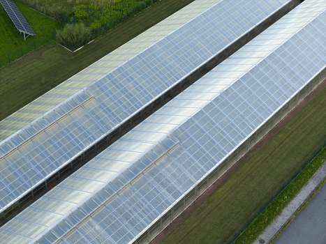Aerial view of the wastewater treatment plant with glass covered structures solar panels and surrounding green fields in Dobczyce Lesser Poland Voivode Poland.