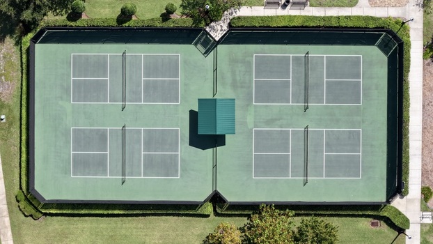 Aerial view of pickleball courts at Windward Ranch Boulevard surrounded by manicured hedges and walkways in St. Johns County Florida United States. Aerial view of pickleball courts at Windward Ranch Boulevard surrounded by manicured hedges and walkways in St. Johns County Florida United States.