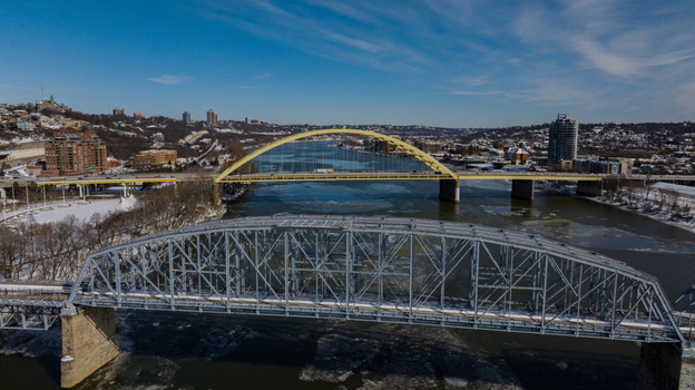 Aerial view of the Big Mac Bridge and Taylor Southgate Bridge spanning the Ohio River with ice floes and snow covered banks in Cincinnati Ohio United States. Aerial view of the Big Mac Bridge and Taylor Southgate Bridge spanning the Ohio River with ice floes and snow covered banks in Cincinnati Ohio United States.