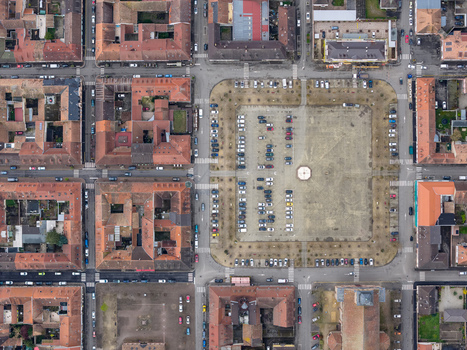 Aerial view of the Place d Armes a vast muted square embraced by orderly buildings under a hazy sky Neuf Brisach Grand Est France.