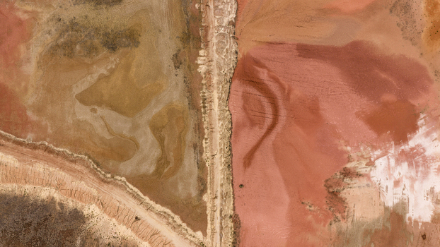 Aerial view of salt production ponds displaying vibrant pink orange and earthy mineral patterns across the landscape in Kalbarri Western Australia Australia. Aerial view of salt production ponds displaying vibrant pink orange and earthy mineral patterns across the landscape in Kalbarri Western Australia Australia.