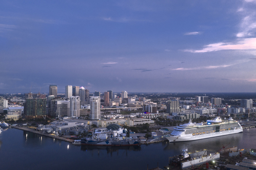 Tampa Florida United States 04 July 2026 Aerial view of Tampa Cruise Terminal 6 with a cruise ship docked at the waterfront featuring the city skyline under a twilight sky.