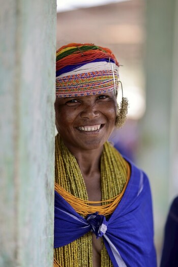 Odisha India 26 March 2026 View of a smiling woman adorned in vibrant traditional clothing her face radiating warmth against the rustic backdrop. Odisha India 26 March 2026 View of a smiling woman adorned in vibrant traditional clothing her face radiating warmth against the rustic backdrop.
