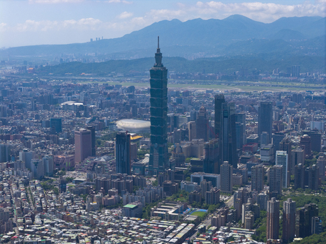 Aerial view of Taipei 101 skyscraper rising above the dense urban landscape of Taipei City Taiwan. Aerial view of Taipei 101 skyscraper rising above the dense urban landscape of Taipei City Taiwan.