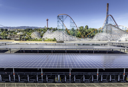 Los Angeles County United States 08 April 2026 Aerial view of Six Flags Magic Mountain amusement park with solar panel carports in the parking lot and roller coasters under a clear blue sky. Los Angeles County United States 08 April 2026 Aerial view of Six Flags Magic Mountain amusement park with solar panel carports in the parking lot and roller coasters under a clear blue sky.
