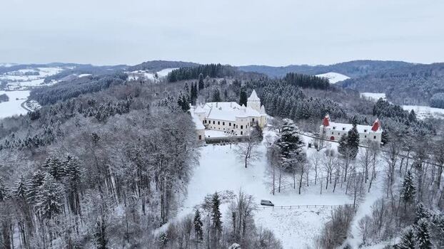 Aerial view of Schloss Kornberg in a snowy forest Austria. Aerial view of Schloss Kornberg in a snowy forest Austria.