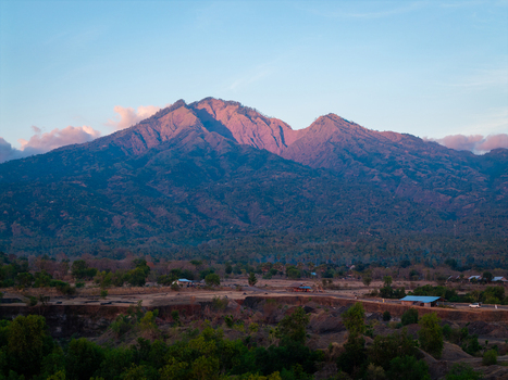 Aerial view of Savana Tianyar and Mount Abang with lush vegetation and golden hour light illuminating the mountain peaks in Kecamatan Kubu Bali Indonesia. Aerial view of Savana Tianyar and Mount Abang with lush vegetation and golden hour light illuminating the mountain peaks in Kecamatan Kubu Bali Indonesia.