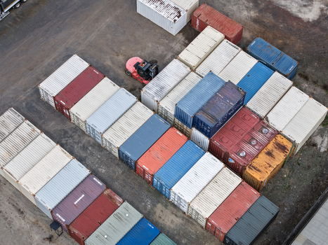 Melbourne VIC Australia 25 September 2026 Aerial view of colorful shipping containers arranged in rows at a logistics yard with a forklift operating nearby.