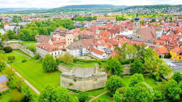 Aerial view of Stadtpark with historic stone fortifications red tiled rooftops of the old town and the St. Martin church tower in Forchheim Bayern Germany. Aerial view of Stadtpark with historic stone fortifications red tiled rooftops of the old town and the St. Martin church tower in Forchheim Bayern Germany.