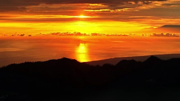 Aerial view of sunset over the ocean in Bali Indonesia.