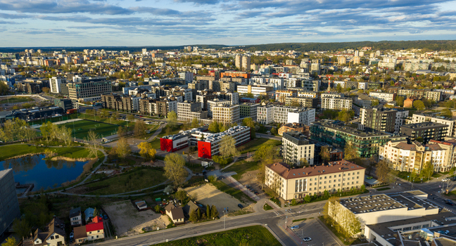 Aerial view of modern residential apartment blocks green parks a football pitch and a small pond in Vilnius County Lithuania. Aerial view of modern residential apartment blocks green parks a football pitch and a small pond in Vilnius County Lithuania.