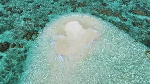 Aerial view of a sandbank surrounded by turquoise water in Maldives. Aerial view of a sandbank surrounded by turquoise water in Maldives.